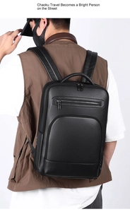 Detailed view of the black lychee grain leather backpack on male model for business travel