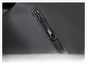 Close-up of matte black metal zippers and waterproof fabric on 16 inch laptop backpack