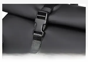 Detail of the durable plastic buckle and nylon webbing on a black waterproof laptop backpack