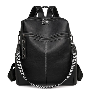 Detail of black leather backpack with white stitching and jacquard strap