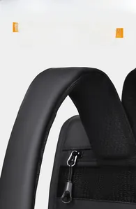 Close-up of padded honeycomb mesh shoulder straps and smooth metal zipper on black backpack