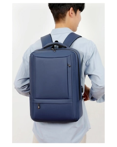 Detail view of a navy business laptop backpack with USB port on a male model