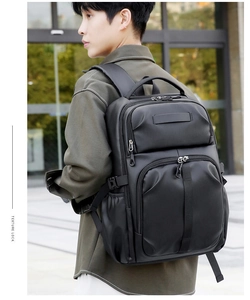 Close-up of lightweight black commuter backpack with large capacity worn by a male model