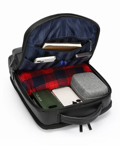 Interior view of black PU leather business backpack showing storage pockets and striped lining