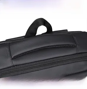 Detail of reinforced padded handle and durable metal zippers on black business backpack