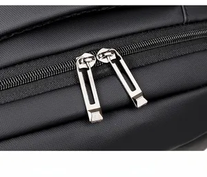 Close-up of smooth metal dual zippers on water-resistant black business laptop backpack