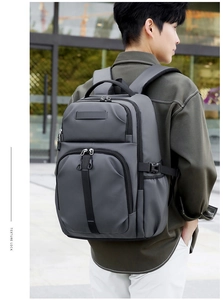 Detail showing thick breathable mesh shoulder straps and side adjustment buckle on grey backpack