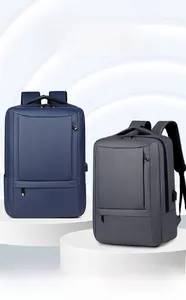 Waterproof nylon business backpacks in navy and grey with integrated USB charging ports