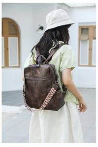 Close-up of brown vintage texture backpack with woven straps on a casual outdoor model