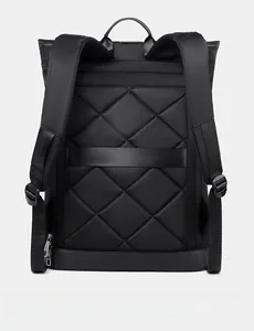 Detail view of breathable quilted back panel with luggage strap on black backpack