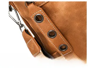 Detailed macro view of retro brown suede bag with precise stitching and metal zipper hardware