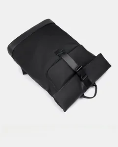 Top view of a minimalist black waterproof nylon backpack with a buckle strap closure