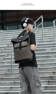 Close-up of stylish roll-top backpack featuring waterproof fabric and buckle on male model