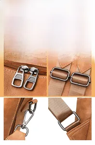Detail of gunmetal zippers and hardware on brown matte leather backpack with fine stitching