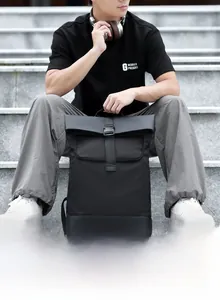 Waterproof nylon roll-top backpack with buckle closure shown in an outdoor lifestyle setting