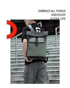 Side view of dark green roll-top backpack with buckle closure and waterproof fabric