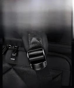 Detail of adjustable shoulder straps with matte black metal buckles on a nylon backpack