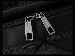 Detail of smooth silver dual metal zippers on a black high-density nylon backpack