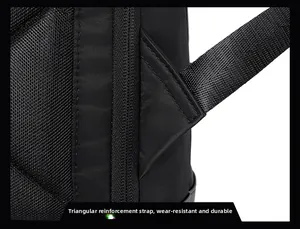 Macro detail of the reinforced triangular strap and durable black nylon fabric on backpack