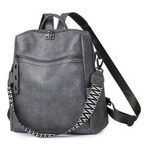 Women's dark grey leather backpack with patterned strap and textured lychee finish