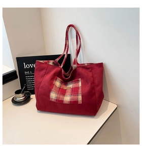 Detail of British style tote bag with vintage red plaid pocket and large canvas interior