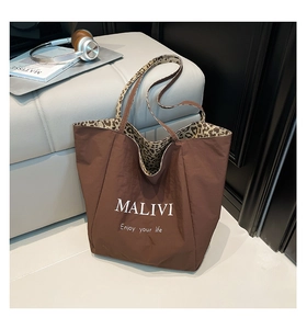 Macro detail of brown tote bag with leopard print lining and MALIVI text branding