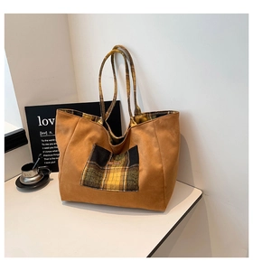 Detail of British style checkered plaid tote bag with brown suede finish and large capacity