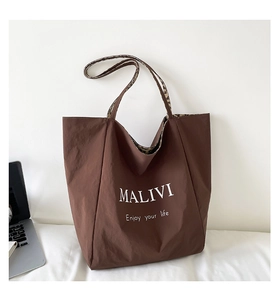 Detail view of the brown nylon tote bag featuring leopard print straps and MALIVI text