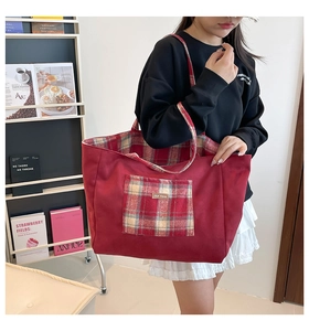 Close-up of red velvet tote bag with plaid pockets and spacious interior for daily use