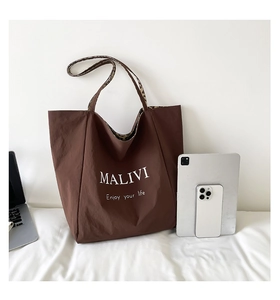Brown canvas tote bag with leopard print lining showing laptop and tablet capacity