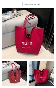 Detail of red tote bag with white text and leopard print lining for daily leisure