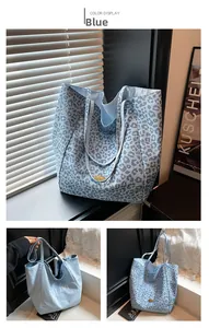 Close-up of blue leopard print canvas tote bag with gold handmade logo and Walivi logo