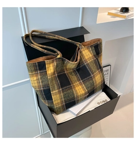 Detailed close-up of British style checkered wool tote bag with thick tweed texture