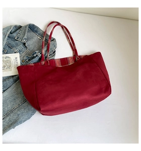 Close-up of red velvet tote bag showing vintage plaid lining and soft texture