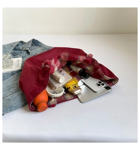Detailed interior of red tote bag showcasing large capacity with daily essentials