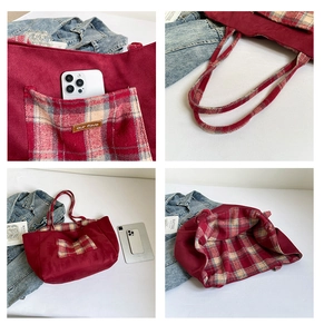 Detail view of burgundy tote bag showing plaid pockets and spacious interior lining