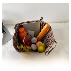Top view of large capacity tote bag with leopard print lining holding a tablet and umbrella