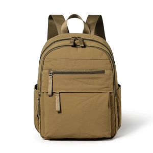Lightweight brown nylon backpack with multiple compartments for travel and daily commuting