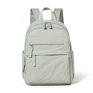 Close-up of waterproof nylon backpack featuring multiple front zipper pockets and side pockets