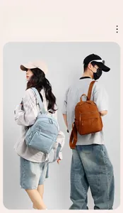 Detail view of lightweight light blue and orange backpacks with water-resistant nylon fabric