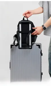 Lightweight black nylon backpack detail showing functional luggage strap for travel