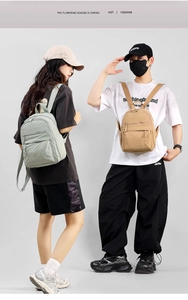 Detail view of mini nylon backpacks in light green and brown colors with zip pocket