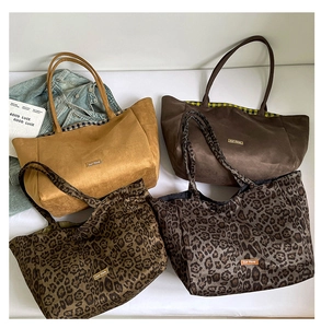 Detailed flat lay of large canvas tote bags in solid colors and leopard patterns