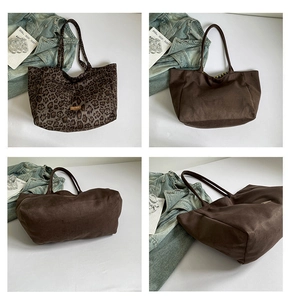 Detail view of large leopard print canvas tote bag with brown straps and logo patch
