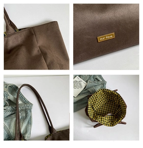 Detailed close-up of dark brown tote bag with check lining and our fave label