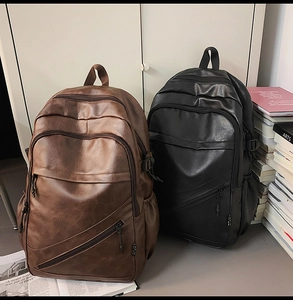Close-up of stylish brown and black faux leather backpacks with multi-pocket design
