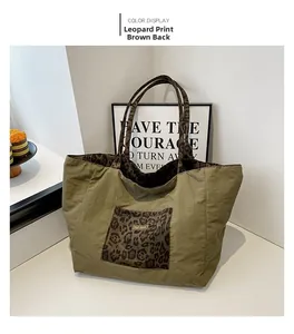 Detail of army green nylon tote bag featuring a leopard print front pocket and woven label