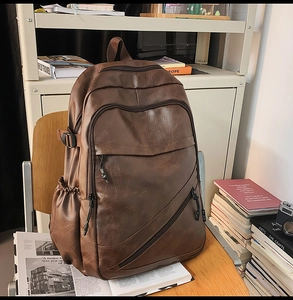 Detail view of premium dark brown PU leather texture and stylish zipper compartments