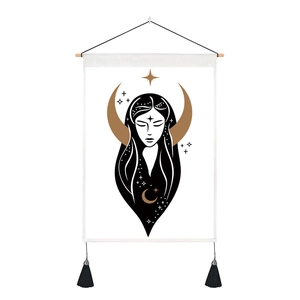 Detail of celestial moon and stars tapestry with wooden rod and black fringe tassels