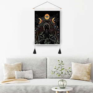 Mystical tapestry with moon and girl pattern hanging above a sofa in a modern living room